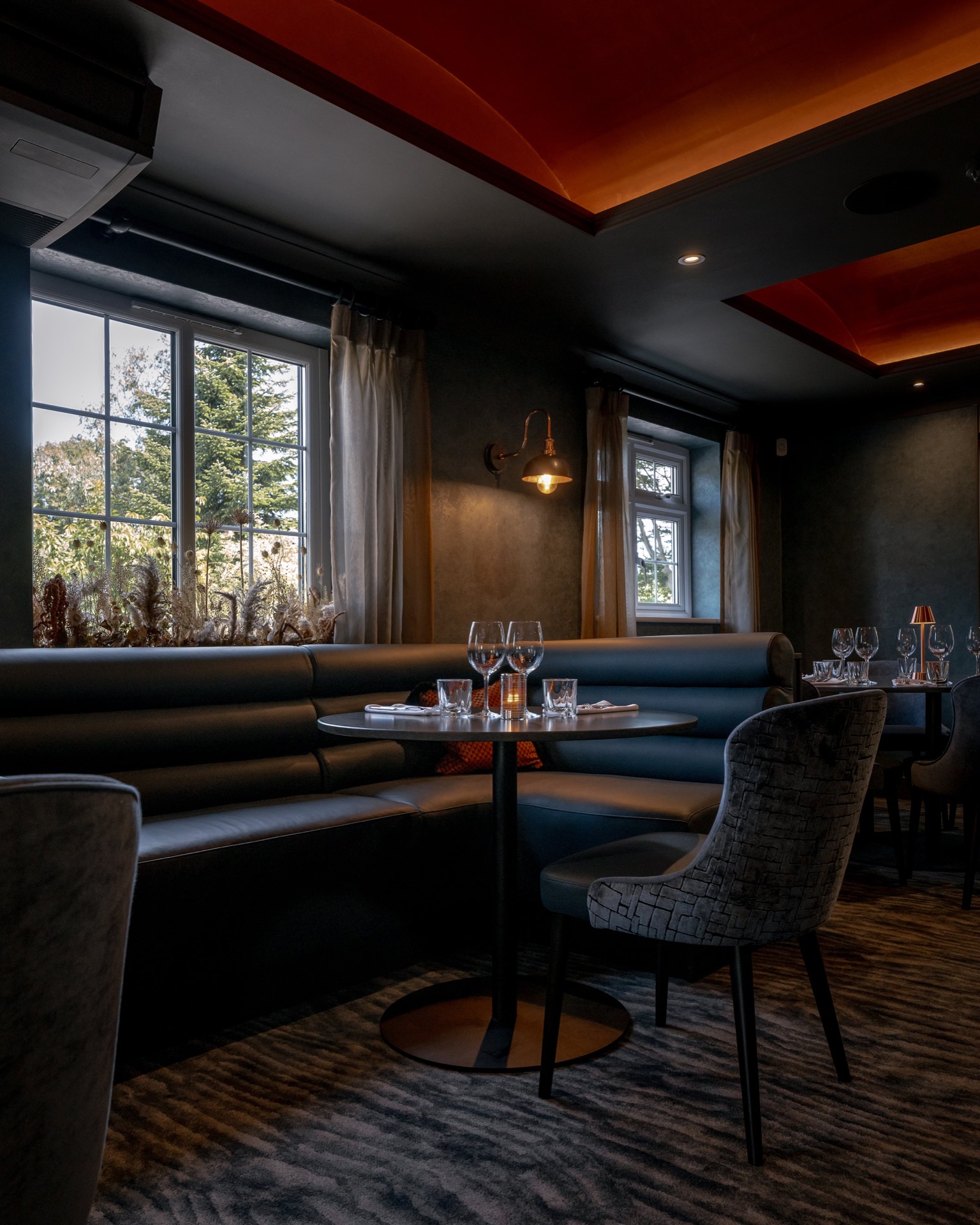 A round table with cushioned booth seating