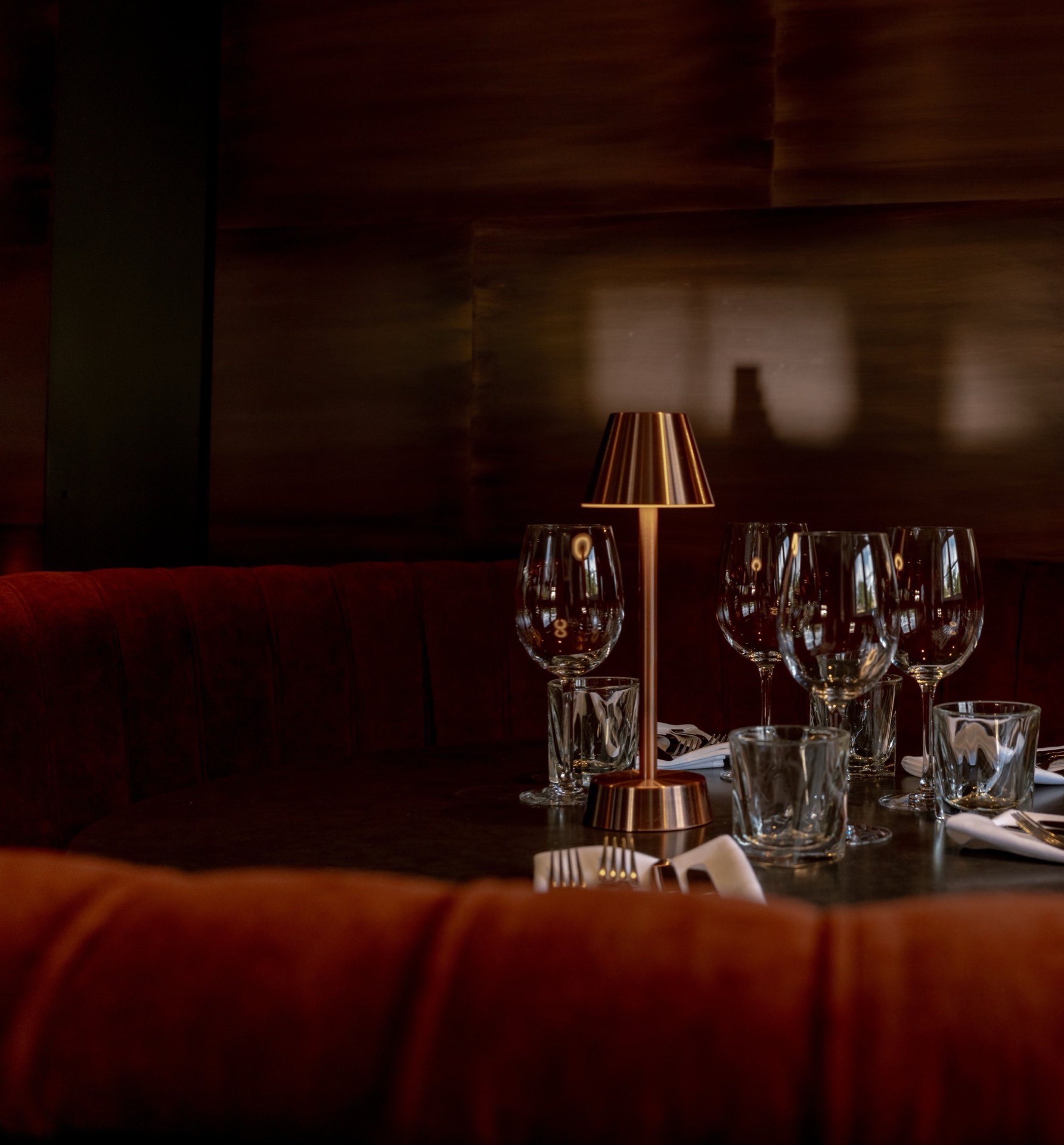 An elegant dining booth with red velvet seating at Mason's