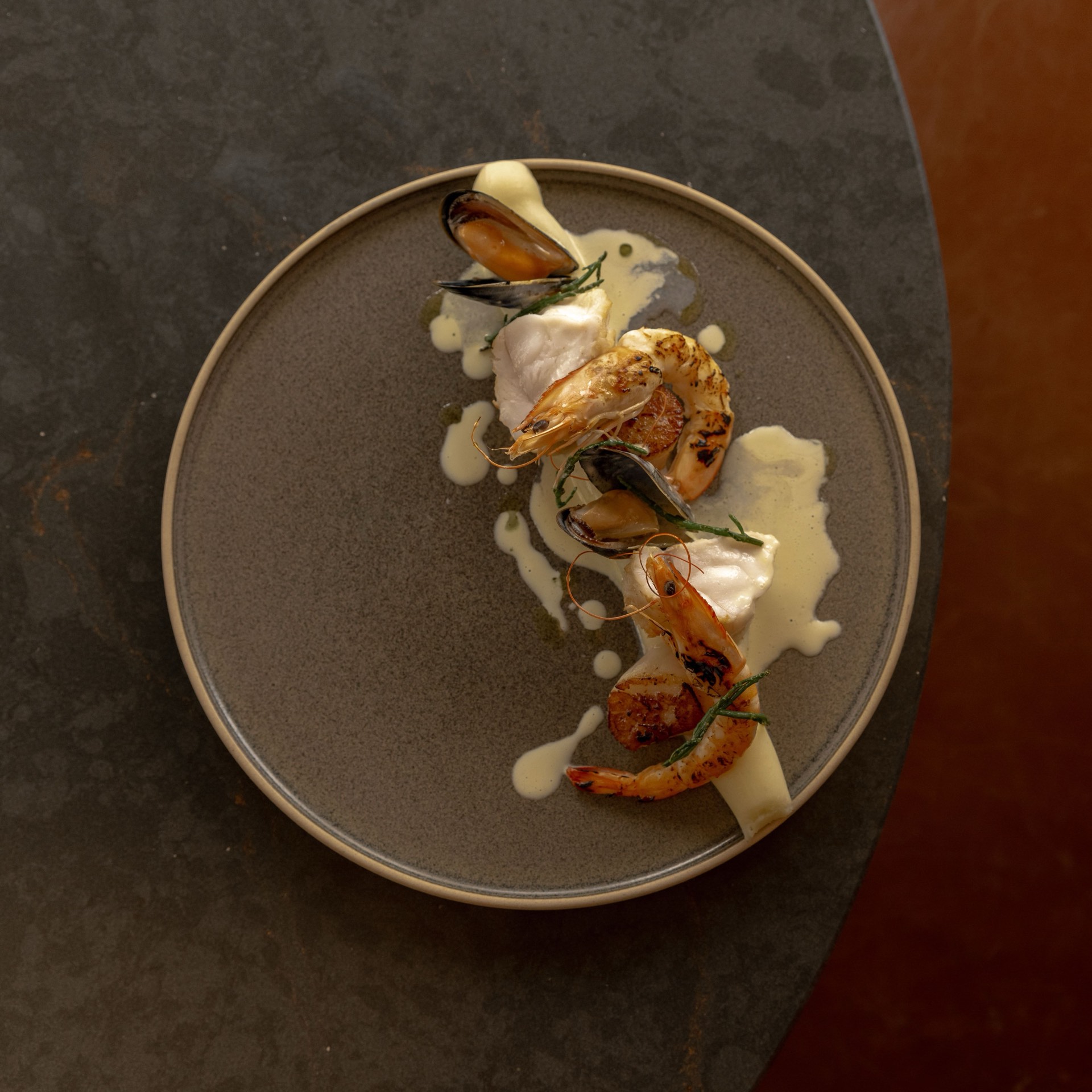 A seafood dish with prawns, mussels and a creamy sauce