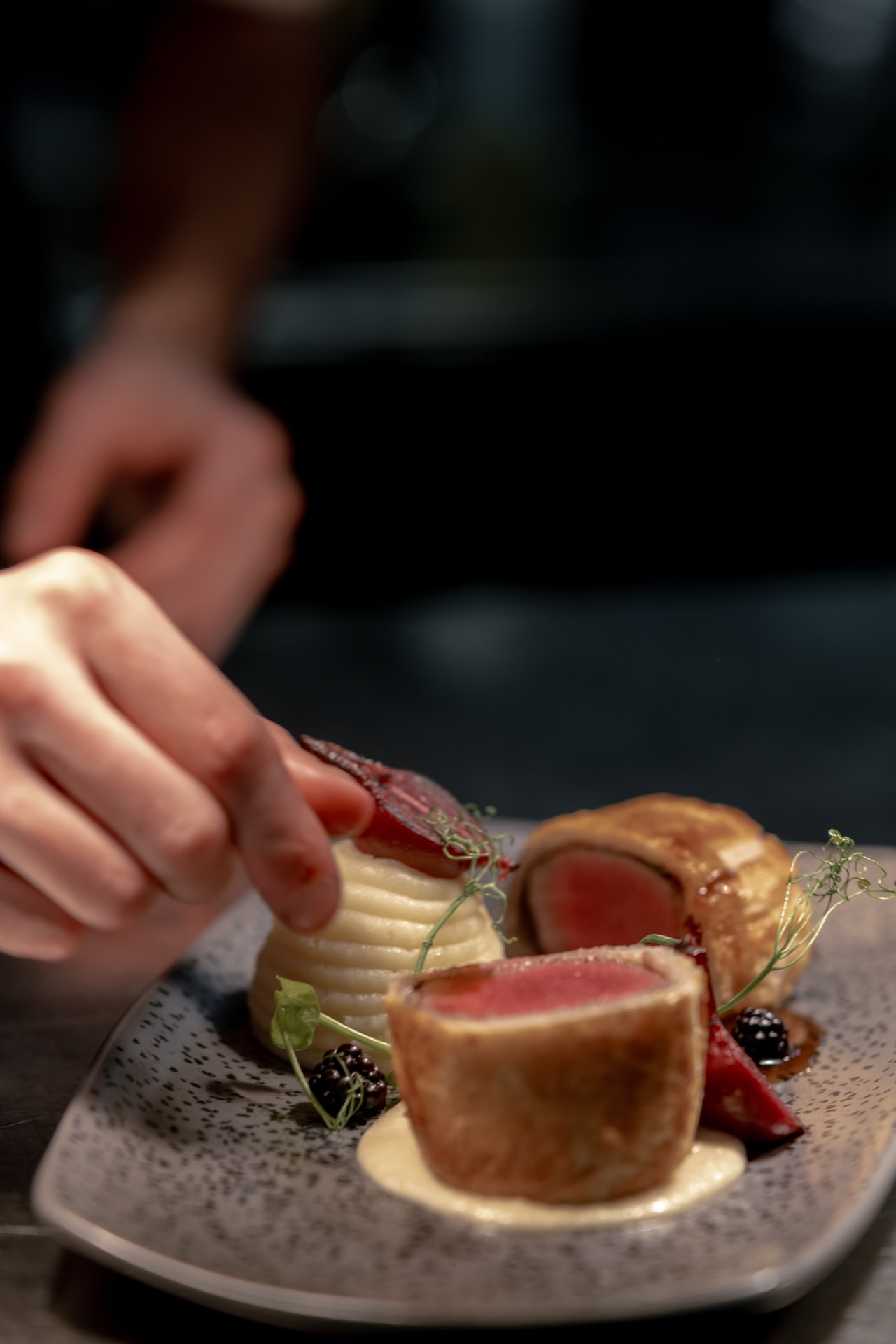 A chef garnishing a dish at Mason's
