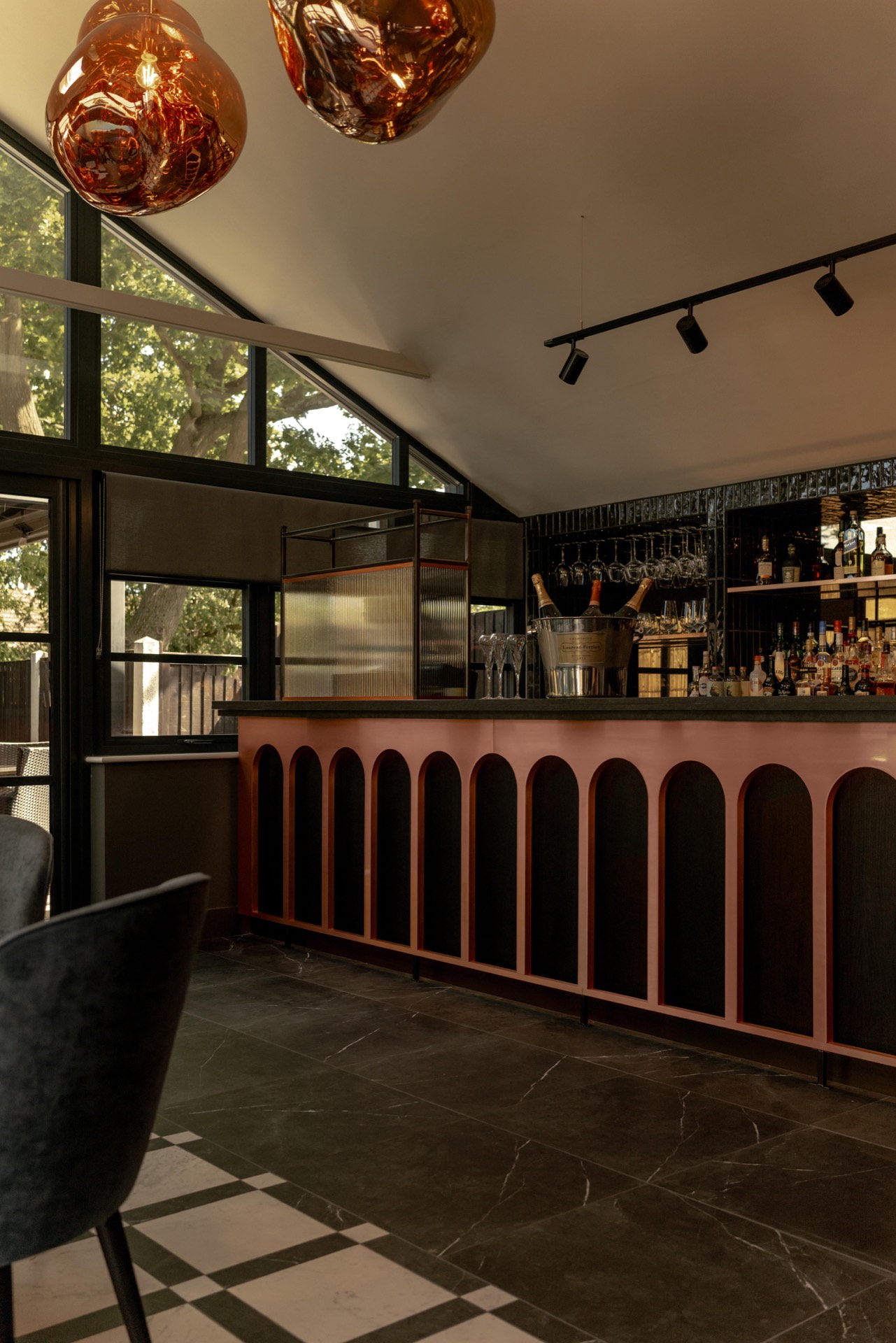 The pink and black arched bar counter