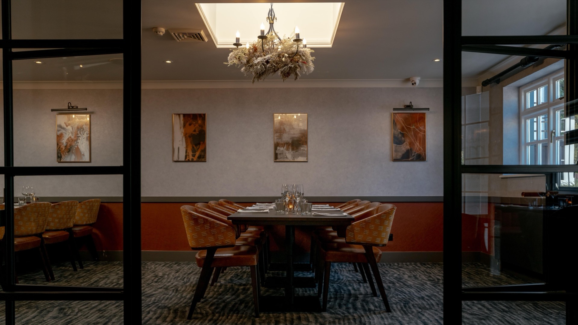 The private dining room at Mason's with a set table and chandelier