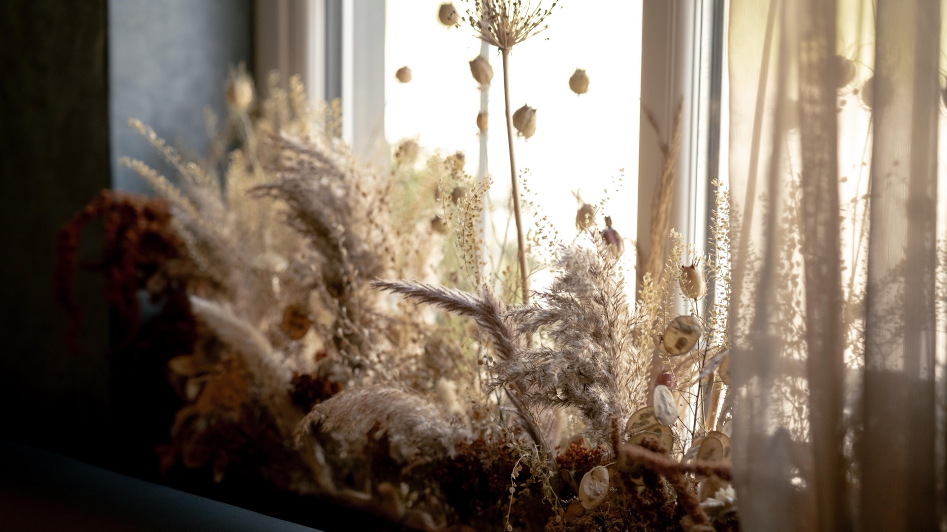 A dried floral arrangement on a windowsill at Mason's