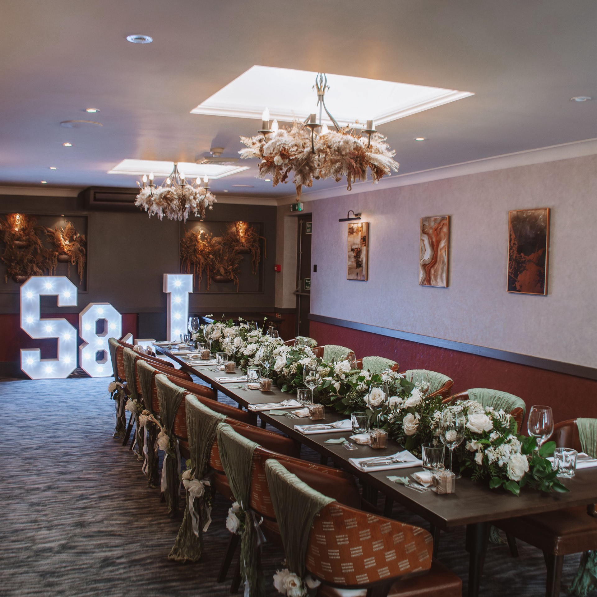 A banquet table dressed with flowers for a wedding