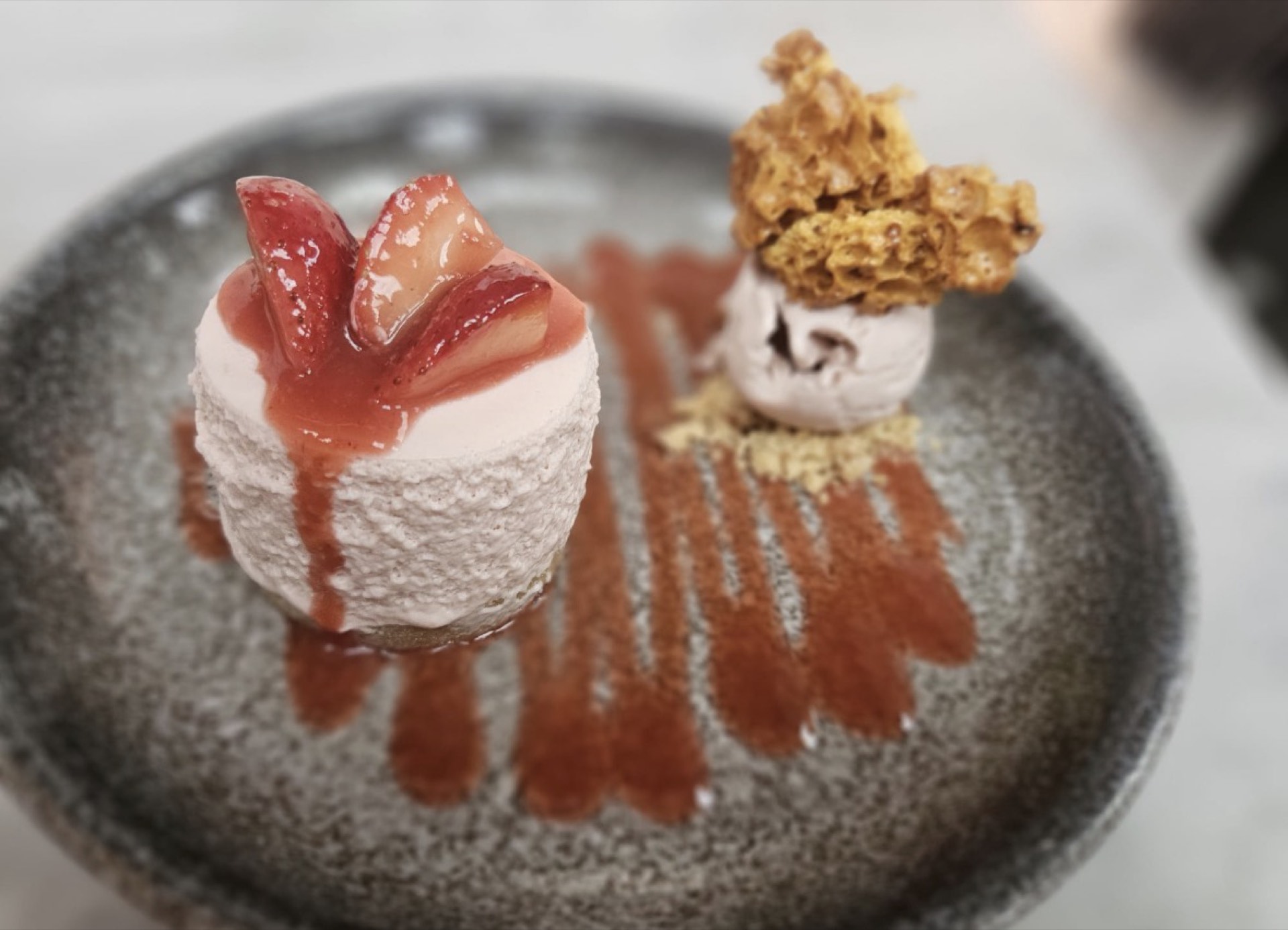 A cheesecake with strawberries and fruit coulis at Mason's